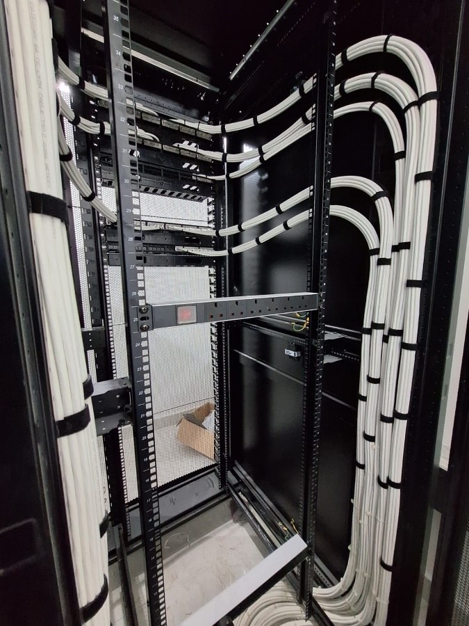 Vertical cable management inside a network cabinet